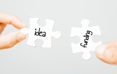 two puzzle pieces that say idea and funding