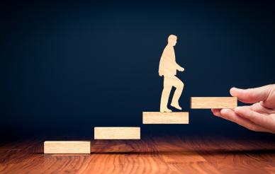 wooden man walking up stairs